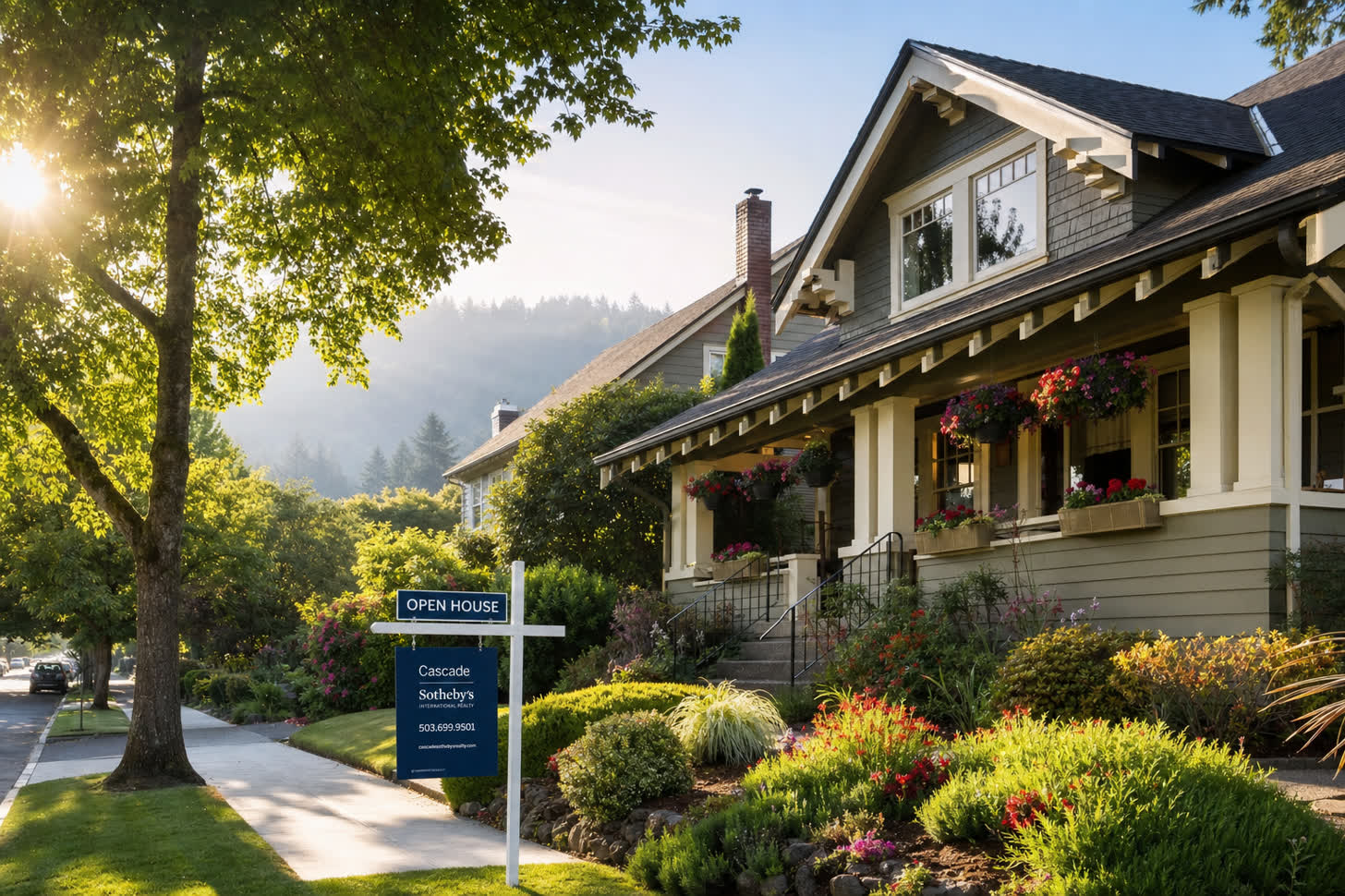 A West Linn craftsman home with an Open House sign on a quiet residential street with hanging flower baskets and morning sunlight filtering through mature trees